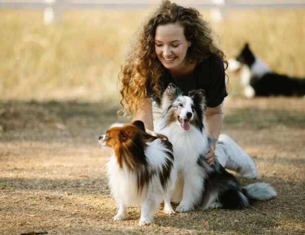 Woman laughing with her two dogs